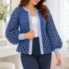 Denim blue crochet cardigan with open diamond mesh sleeves and pale blue ribbed cuffs worn over white top